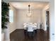 Bright dining room featuring modern lighting and dark hardwood floors at 3062 Hawthorn Farm Blvd, Loganville, GA 30052