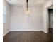 Empty dining room featuring modern lighting and dark hardwood floors at 3062 Hawthorn Farm Blvd, Loganville, GA 30052