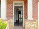 Inviting entryway with wood floors, brick columns, and a view into the home at 3062 Hawthorn Farm Blvd, Loganville, GA 30052
