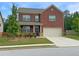 Charming two-story brick home with well-maintained landscaping and a two-car garage at 3062 Hawthorn Farm Blvd, Loganville, GA 30052