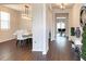 View of a hallway with elegant lighting that opens to the dining and living areas at 3062 Hawthorn Farm Blvd, Loganville, GA 30052
