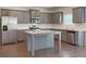 Modern kitchen with gray cabinetry, stainless steel appliances, and granite countertops at 3062 Hawthorn Farm Blvd, Loganville, GA 30052