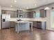 Contemporary kitchen features stainless steel appliances, granite countertops, and an island at 3062 Hawthorn Farm Blvd, Loganville, GA 30052
