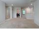 Open living area with laundry room and hallway entrances at 3062 Hawthorn Farm Blvd, Loganville, GA 30052