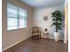 Cozy living room with hardwood floors, a chair and a large window at 3062 Hawthorn Farm Blvd, Loganville, GA 30052