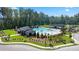 Aerial view of a community pool area with cabanas, lounge chairs and splash pad in a wooded setting at 3062 Hawthorn Farm Blvd, Loganville, GA 30052