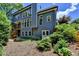View of the backyard of this home featuring lush greenery and tall windows at 3715 Horizon Ct, Cumming, GA 30041