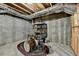 Unfinished basement storage area with exposed beams and concrete walls featuring a drumset at 3715 Horizon Ct, Cumming, GA 30041