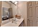 Clean bathroom vanity with neutral walls, modern fixtures, and adjacent bedroom at 3715 Horizon Ct, Cumming, GA 30041