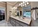 Stylish bathroom featuring a double vanity, decorative mirrors, and access to a walk-in closet, combining functionality with elegance at 3715 Horizon Ct, Cumming, GA 30041