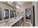 Bathroom boasts double sinks, a large mirror, and entry to another room and water closet at 3715 Horizon Ct, Cumming, GA 30041