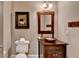 Charming powder room with a rustic wood vanity, vessel sink, and unique wall art, offering a cozy, stylish space at 3715 Horizon Ct, Cumming, GA 30041