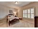 Cozy bedroom featuring a comfortable bed, shutters, and plush carpeting at 3715 Horizon Ct, Cumming, GA 30041