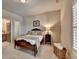 Cozy bedroom with neutral walls, shutters, carpet, and an ensuite bath at 3715 Horizon Ct, Cumming, GA 30041