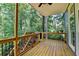 View from the deck showcasing wood flooring, black railings, and views of the backyard at 3715 Horizon Ct, Cumming, GA 30041