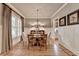 Classic dining room with hardwood floors, decorative molding, and elegant furnishings, perfect for entertaining at 3715 Horizon Ct, Cumming, GA 30041