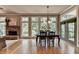 Inviting dining room with large windows and natural light, stone fireplace, and hardwood floors at 3715 Horizon Ct, Cumming, GA 30041
