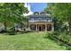 Charming two-story home with manicured lawn, complemented by lush landscaping and mature trees at 3715 Horizon Ct, Cumming, GA 30041