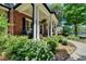 Charming front porch with classic brickwork, featuring decorative planters and a cozy seating area at 3715 Horizon Ct, Cumming, GA 30041