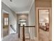 Hallway offering a glimpse into a bedroom with natural light, highlighting the home's spacious and inviting layout at 3715 Horizon Ct, Cumming, GA 30041