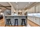 Kitchen with breakfast bar, granite countertops, stainless steel appliances, and hardwood floors at 3715 Horizon Ct, Cumming, GA 30041