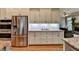 Bright kitchen boasts stainless steel appliances, granite countertops, and ample cabinet space at 3715 Horizon Ct, Cumming, GA 30041