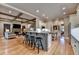 Open concept kitchen with breakfast bar island that flows into the living room with fireplace at 3715 Horizon Ct, Cumming, GA 30041