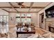Spacious living room features coffered ceilings, a stone fireplace, and tons of natural light at 3715 Horizon Ct, Cumming, GA 30041
