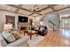 View of the living room featuring coffered ceilings, a stone fireplace and built-in shelving at 3715 Horizon Ct, Cumming, GA 30041