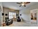 Living room with leather seating, a window with plantation shutters, and access to another room at 3715 Horizon Ct, Cumming, GA 30041