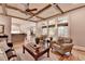 Spacious living room features coffered ceilings, a stone fireplace, and tons of natural light at 3715 Horizon Ct, Cumming, GA 30041