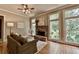 Bright living room features a stone fireplace, hardwood floors, and large windows at 3715 Horizon Ct, Cumming, GA 30041