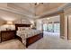Spacious main bedroom with a trey ceiling, sitting area with a view, and ample space, creating a luxurious retreat at 3715 Horizon Ct, Cumming, GA 30041
