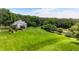 Aerial view of the property showcasing a large, well-manicured lawn with surrounding trees at 3715 Horizon Ct, Cumming, GA 30041