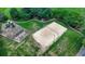 Aerial view of a sand volleyball court and playground in a well-maintained community park with walking paths and mature trees at 3715 Horizon Ct, Cumming, GA 30041