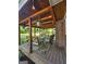 Inviting covered back porch with outdoor seating, decorative lighting, and wood-paneled ceiling, perfect for relaxing outdoors at 4715 Howard Dr, Powder Springs, GA 30127