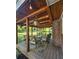 Comfortable covered back porch with seating area, string lights and wood beam roof at 4715 Howard Dr, Powder Springs, GA 30127