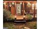 Cozy covered back porch with outdoor furniture, string lights, and landscaped surroundings, ideal for evening gatherings at 4715 Howard Dr, Powder Springs, GA 30127