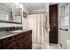 Well-lit bathroom features a dark-wood vanity with granite countertop and walk-in shower at 4715 Howard Dr, Powder Springs, GA 30127