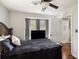 Cozy bedroom with a ceiling fan, dark wood furniture, and a window with curtains for privacy at 4715 Howard Dr, Powder Springs, GA 30127