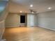 Large bonus room with a ceiling fan, laminate flooring, and a door leading to other areas at 4715 Howard Dr, Powder Springs, GA 30127