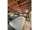 Well lit garage featuring storage, a covered car, and motorcycle with wood paneling at 4715 Howard Dr, Powder Springs, GA 30127