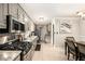 Beautiful kitchen with stainless steel appliances, granite countertops, and adjacent dining area with ample lighting at 4715 Howard Dr, Powder Springs, GA 30127