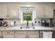 Well-lit kitchen sink area with granite countertops, modern faucet, and a view of the green outdoors at 4715 Howard Dr, Powder Springs, GA 30127
