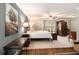 Comfortable bedroom boasts a four-poster bed, neutral decor, ceiling fan and hard wood floors at 4715 Howard Dr, Powder Springs, GA 30127