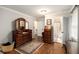 Bright main bedroom featuring hardwood floors, antique vanity and ensuite bathroom at 4715 Howard Dr, Powder Springs, GA 30127
