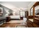 Spacious primary bedroom with a four-poster bed, hardwood floors, and lots of natural light at 4715 Howard Dr, Powder Springs, GA 30127