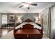 Bright primary bedroom with a four-poster bed, hardwood floors, and modern lighting at 4715 Howard Dr, Powder Springs, GA 30127