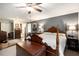 Bright main bedroom featuring neutral carpet, a four-poster bed, and ensuite bathroom at 4715 Howard Dr, Powder Springs, GA 30127