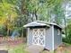 Outdoor shed with white trim and crossbuck doors, ideal for storage and organization at 4715 Howard Dr, Powder Springs, GA 30127